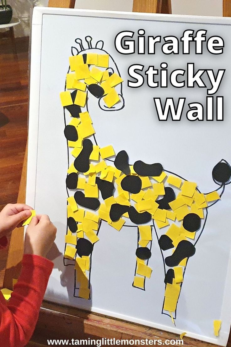 a child is painting a giraffe sticky wall