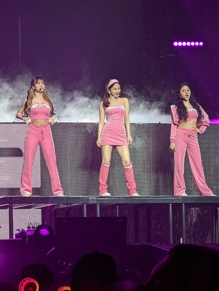 the girls in pink outfits are performing on stage