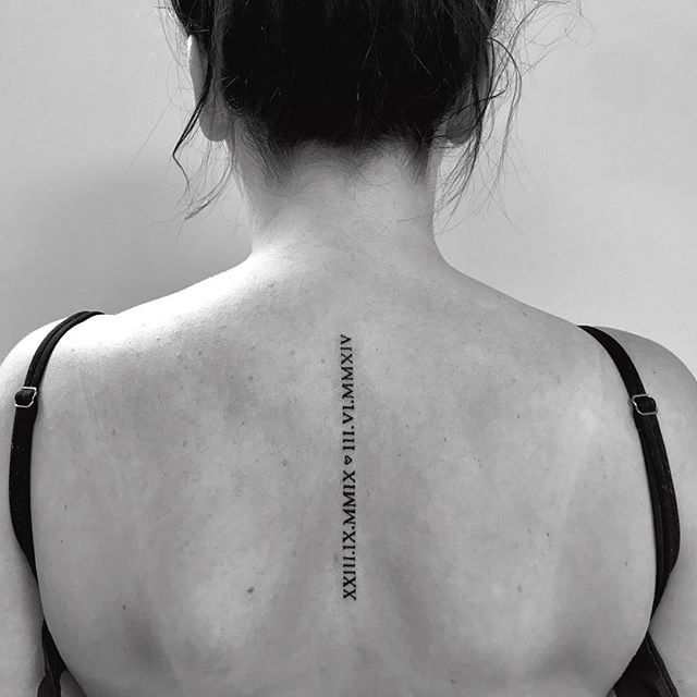 the back of a woman's neck with an inscription on it that reads,