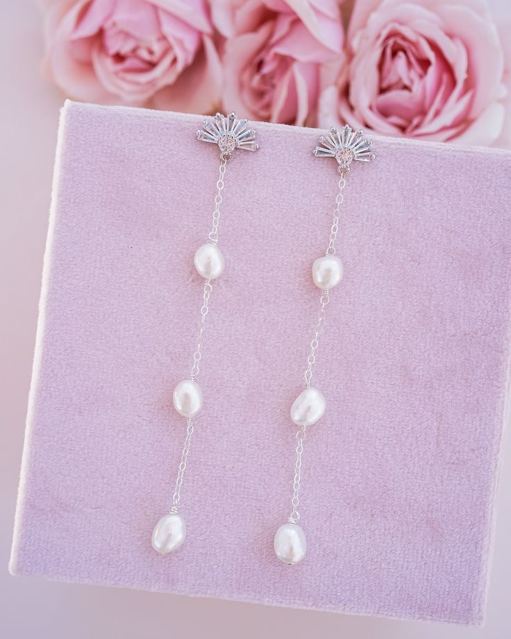 The Daisy Pearl Drop Earrings are the newest addition to our collection! These earrings are a must-have accessory for anyone who appreciates dainty and elegant jewelry. What do we love about them? These earrings are a beautifully crafted accessory that combines the natural beauty of freshwater pearls with the simplicity of a 14k gold-filled or sterling silver wire and chain. With their impeccable craftsmanship and stunning design, they are sure to become a treasured piece in your jewelry collect Freshwater Pearls Earrings, How To Apply Makeup, Polish Jewelry, Gold Filled Jewelry, Pearl Drop Earrings, Pearl Drop, Elegant Jewelry, Cleaning Jewelry, Silver Wire