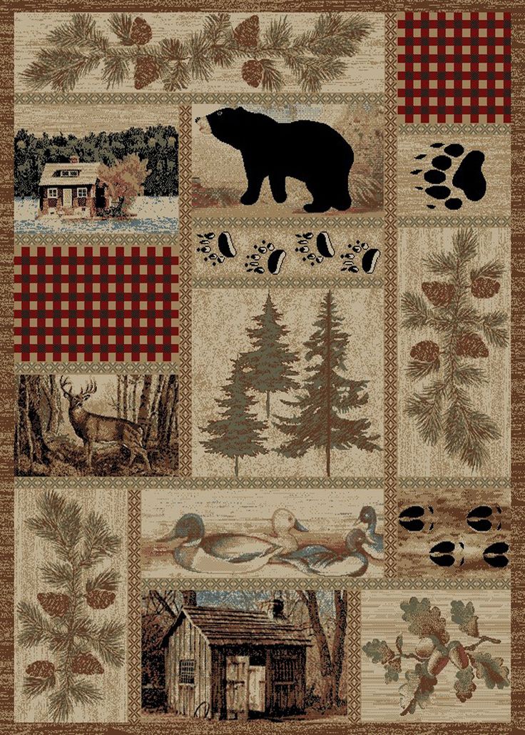 a bear and pine tree themed quilt with many different pictures on it, including an image of a cabin