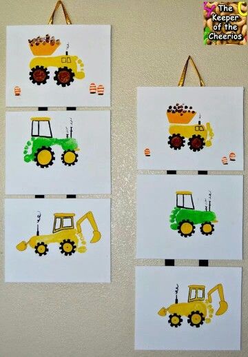 two pictures of construction vehicles are on the wall next to each other, and one is made out of paper