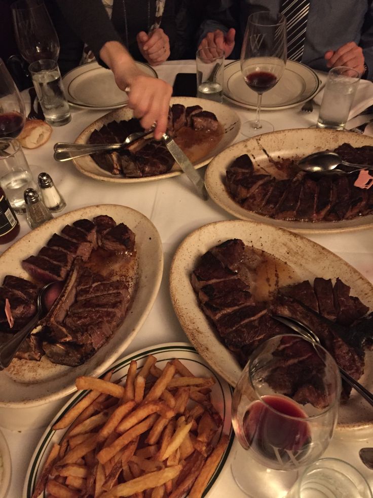 a table topped with lots of plates filled with food