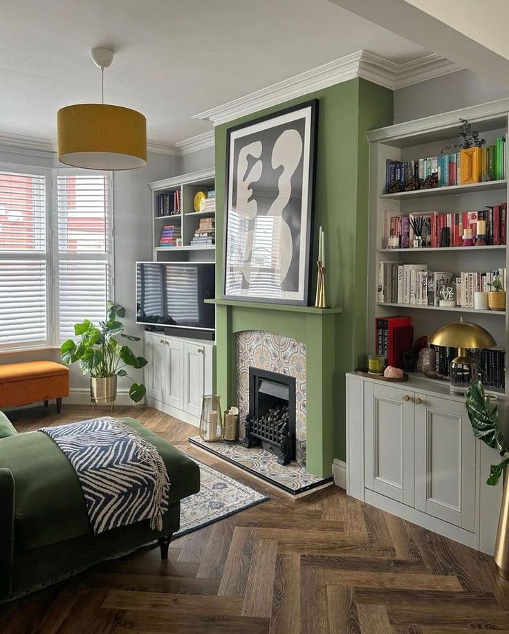 a living room filled with furniture and a flat screen tv mounted to a wall next to a fire place