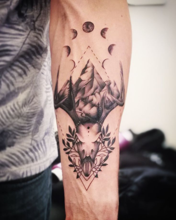 a man with a tattoo on his arm and an animal head in the middle of it