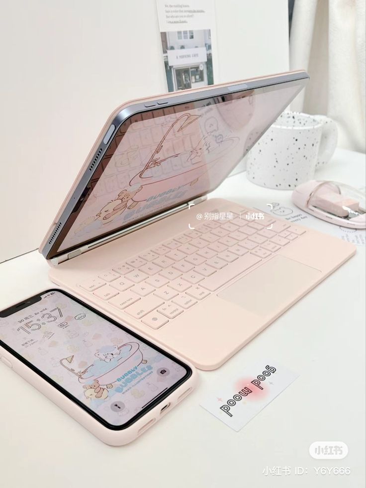 an open laptop computer sitting on top of a white desk