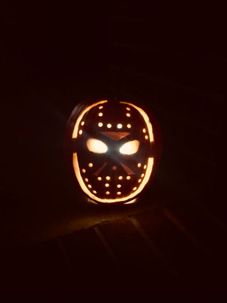 an illuminated mask with glowing eyes in the dark