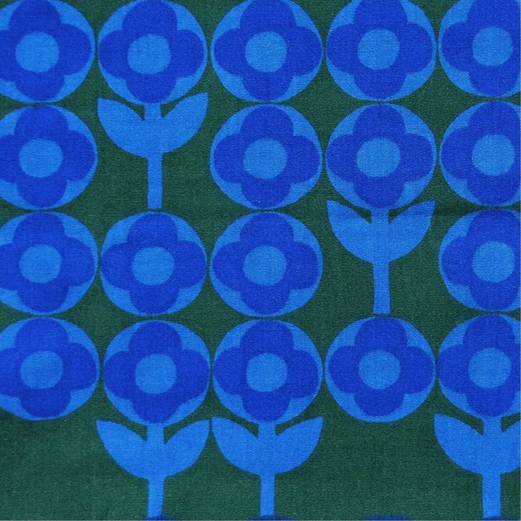 a blue flower pattern on green fabric