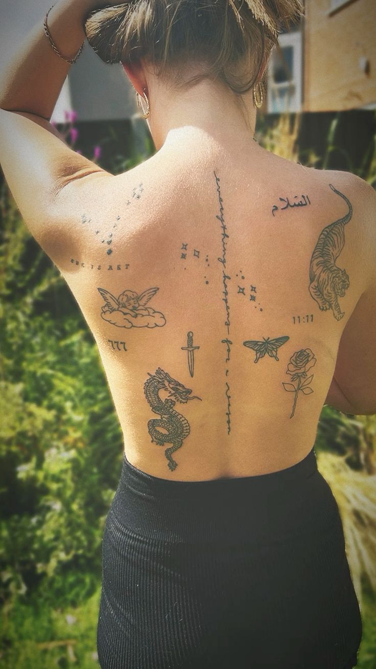 a woman with tattoos on her back is looking at the sky and stars in the sky