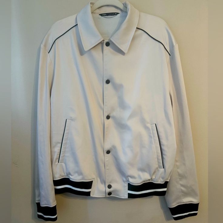 Absolutely Beautiful Bomber Jacket! Never Worn, Nwot But Took Tag Off Out Of Habit. It Is An Absolute Exquisite Staple For Any Man’s Closet! Goes With Everything. It Is Extremely Sophisticated, Luxurious, And You Can Dress It Up Or Down. Sad To Part With This Item, But Lost Weight And It Just Stayed In My Closet For A Long Time. Cream Color/ Off White. Silky Sheen Material. Durable. Black Metal Button Clasps. Exposed Stitching Throughout. Amazing Detail Pipeline Design On Shoulder And Pockets In White Outerwear With Ribbed Collar For Fall, Fall White Outerwear With Ribbed Collar, White Outerwear With Ribbed Collar For Spring, White Streetwear Outerwear With Padded Collar, Casual White Outerwear With Contrast Collar, Fitted White Outerwear With Ribbed Cuffs, White Ribbed Collar Outerwear For Spring, White Track Jacket With Ribbed Collar For Winter, White Outerwear With Ribbed Collar For Streetwear