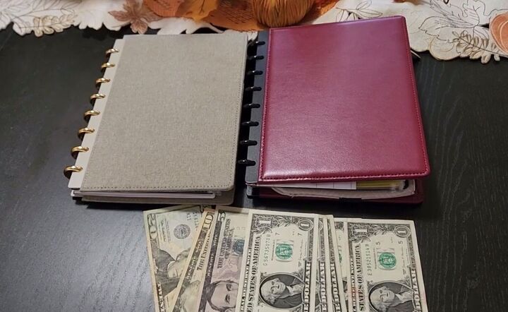 two notebooks with money sitting next to each other