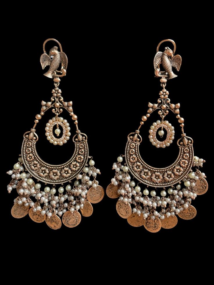 These oxidized earrings come in two beautiful colors with an antique gold finish to complete the royal look. They are very comfortable to wear and the colors are subtle with antique gold work to not overpower the look of the statement earrings. Festive Brass Temple Jewelry Chandelier Earrings, Festive Brass Chandelier Earrings In Temple Jewelry Style, Gold Dual-tone Chandbali Earrings, Temple Jewelry Bridal Chandbali Earrings In Brass, Temple Jewelry Chandbali Bridal Earrings In Brass, Elegant Antique Finish Earrings For Festive Occasions, Bohemian Kundan Chandbalis With Intricate Design, Traditional Gold Copper Earrings, Antique Gold Earrings With Intricate Design For Festive Occasions