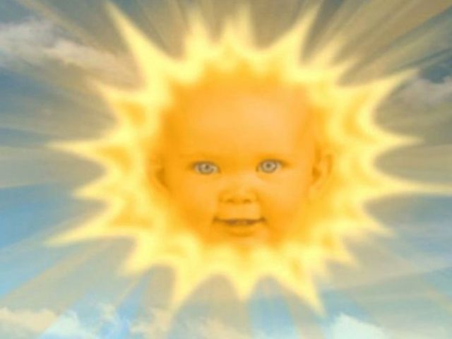 an image of a baby's face in the sky with sun shining over it