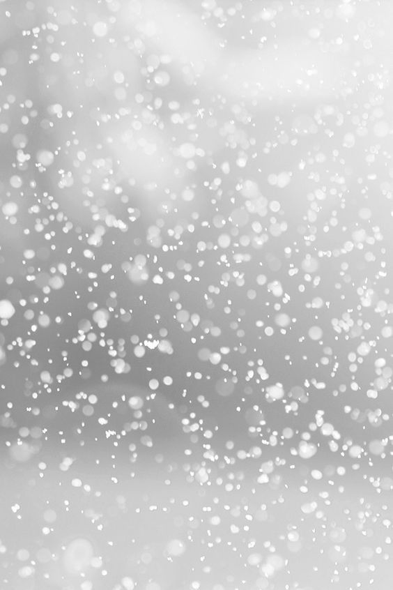 black and white photo of rain falling down on the window with blurry sky in background