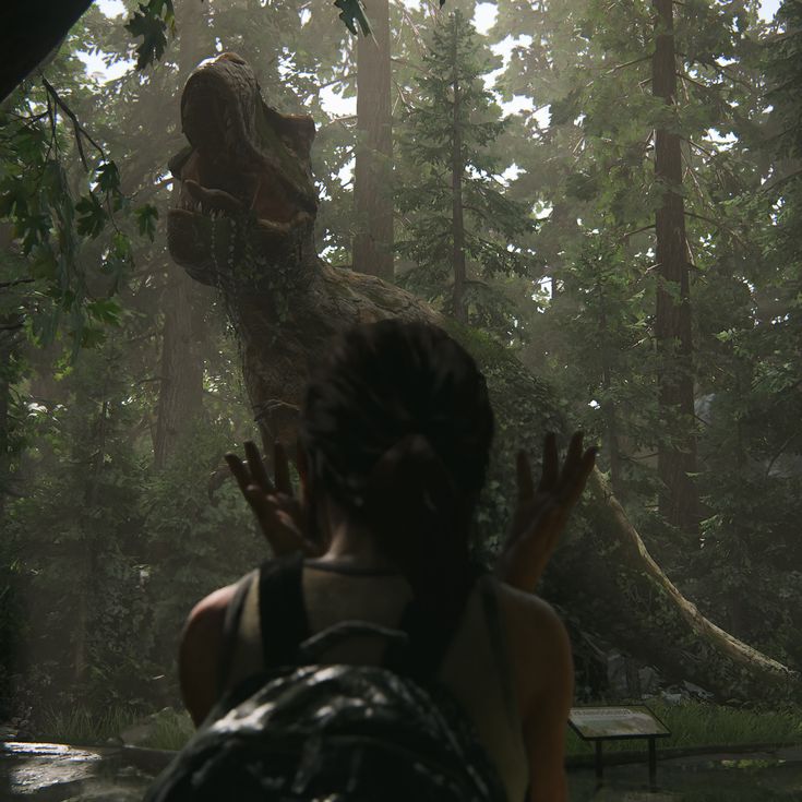 a woman standing in front of a large dinosaur in the middle of a forest filled with trees