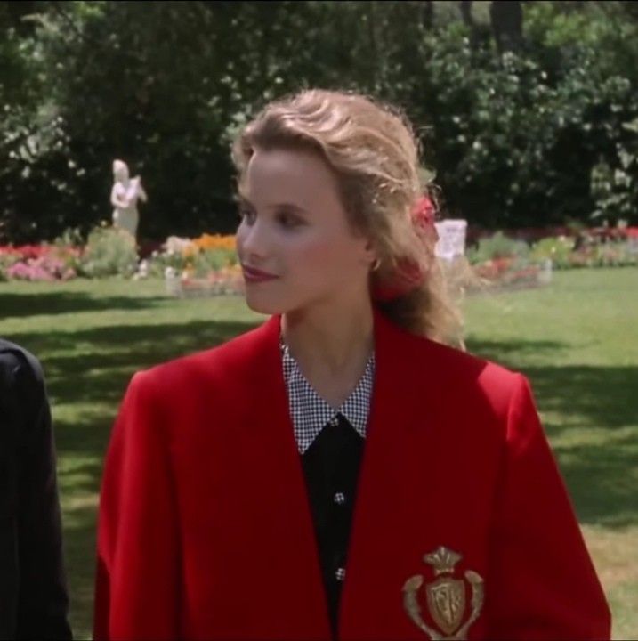 a woman in a red jacket standing next to another woman