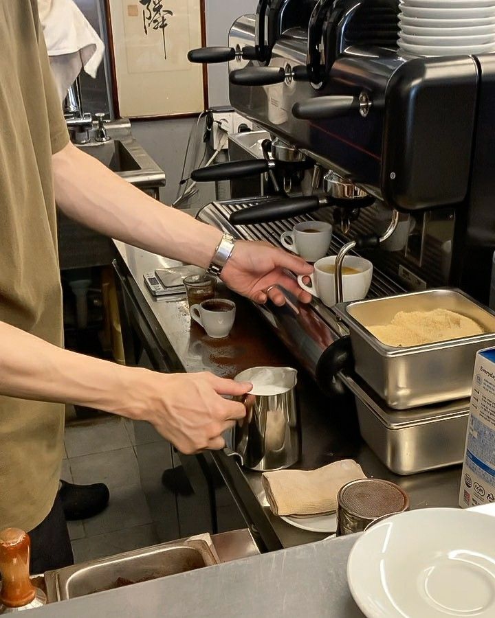 two people are preparing food in a restaurant kitchen