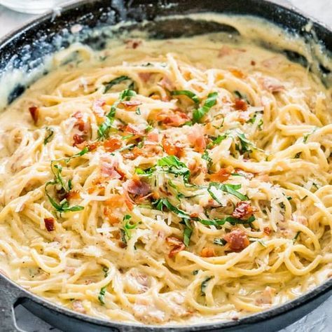 a skillet filled with pasta and bacon