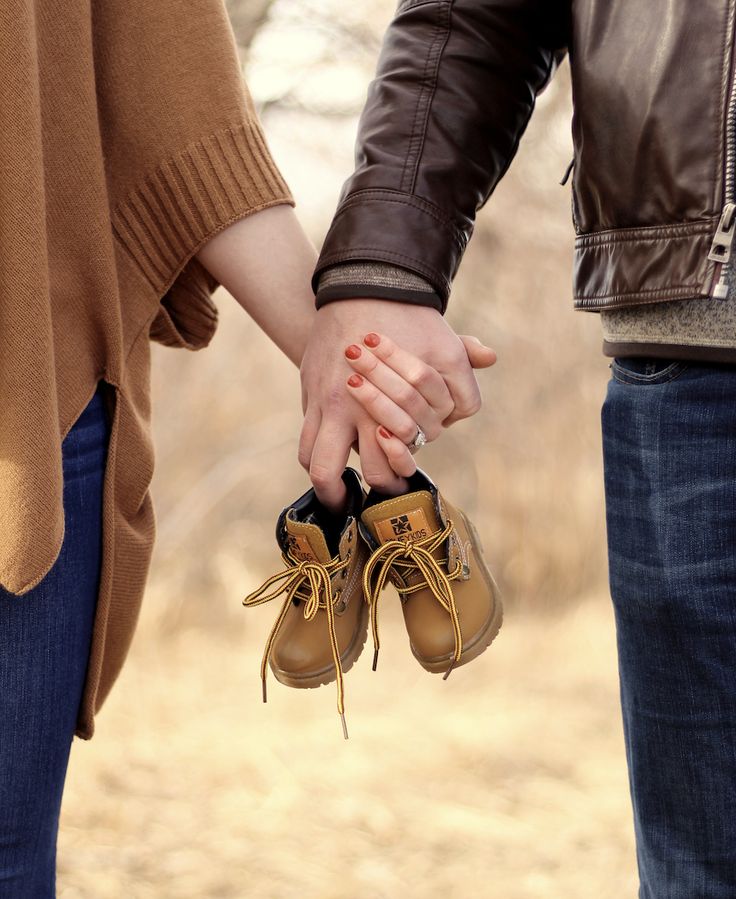 two people holding hands while standing next to each other