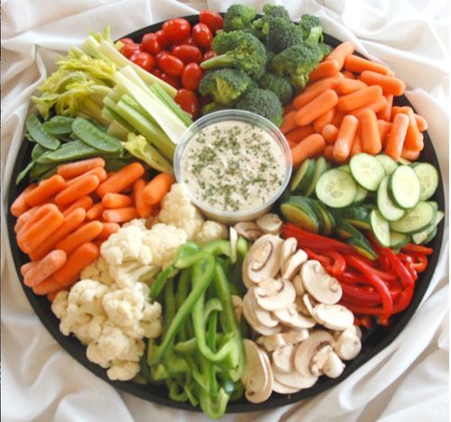 a platter filled with vegetables and dip