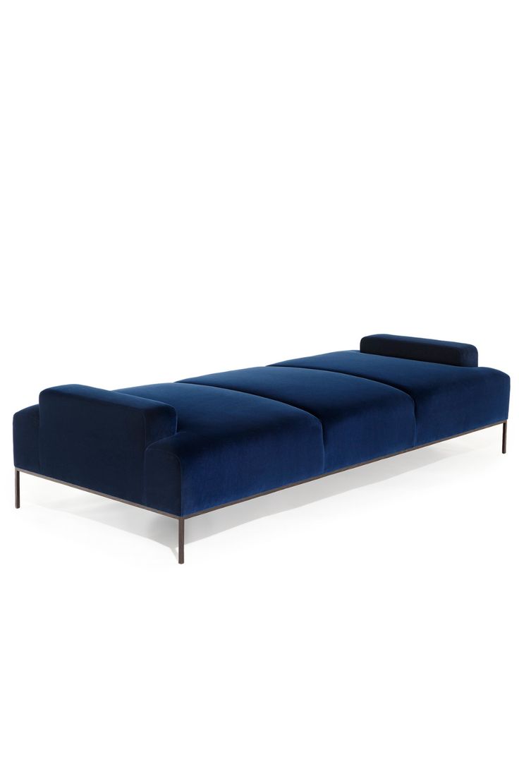 a blue couch sitting on top of a white floor