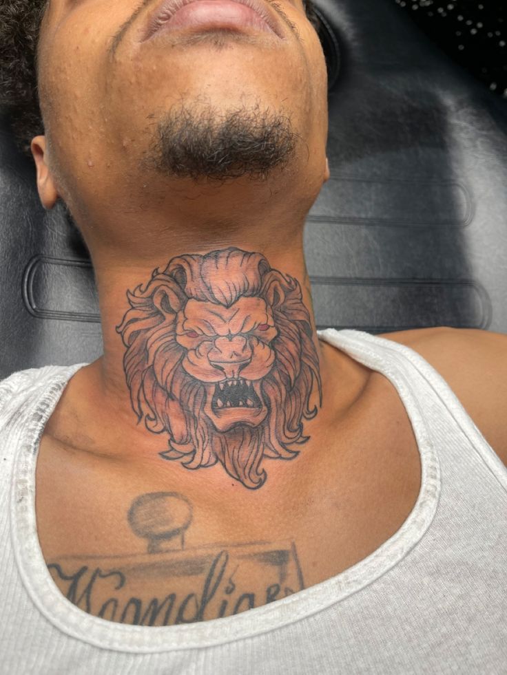 a man with a lion tattoo on his neck