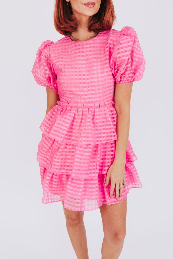 The Pinky Swear Dress is full of fun and quirky features to make you stand out! Puffy sleeves, tiered layers, and a ruffle waist detail add whimsy, while a mesh overlay adds texture. Trust us, you'll be making a pinky swear to never take this dress off. Details Puffy sleeves Tiered Ruffle waist detail Mesh overlay Fully lined Sizing Approximate measurements: SIZE LENGTH BUST Small 35"﻿ 34"﻿ Medium 36"﻿ 36"﻿ Large 36"﻿ 38"﻿ Fabric has no stretchModel is 5’10 wearing small Material 100% PolyesterH Fitted Flirty Tiered Dress, Feminine Tiered Puff Sleeve Dress With Ruffles, Chic Mini Dress With Ruffles And Bubble Hem, Fitted Tiered Puff Sleeve Dress With Ruffles, Flirty Fitted Tiered Dress, Pink Mini Tiered Dress With Ruffles, Pink Mini Tiered Ruffled Dress, Pink Mini Tiered Dress With Ruffled Skirt, Pink Ruffled Mini Length Tiered Dress