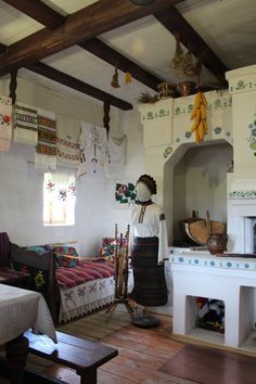 a living room filled with furniture and a fire place next to a kitchen stove top oven