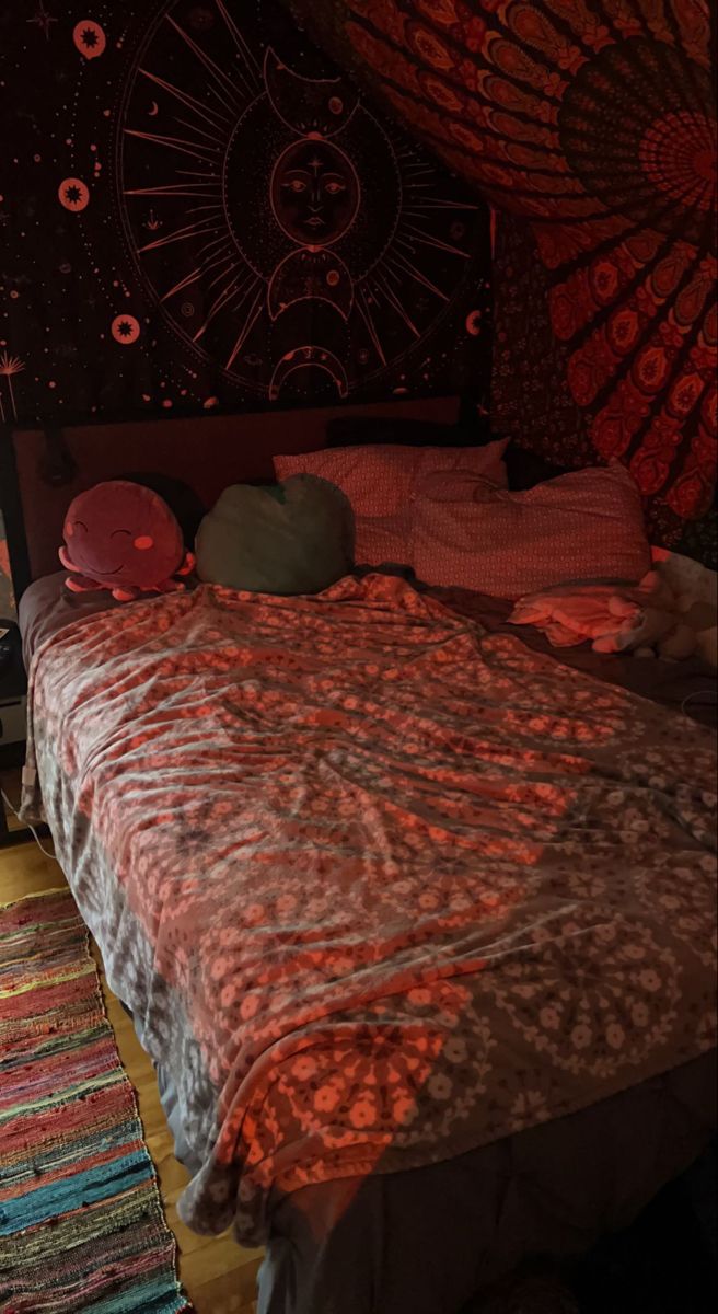 a bed in a room with red lights on the wall and rugs around it