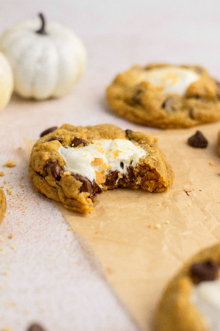 chocolate chip cookies with marshmallows and white frosting on a cutting board