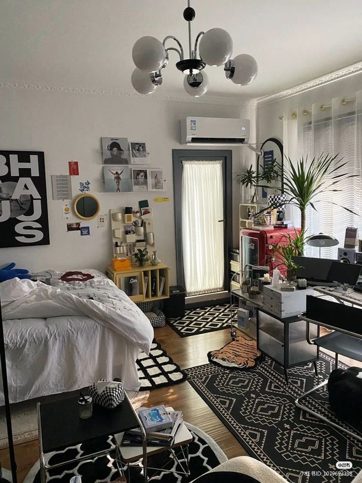 a bedroom with black and white rugs and pictures on the wall above the bed