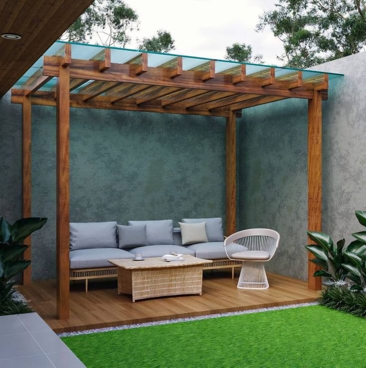 an outdoor living area with couches, tables and plants on the grass covered deck