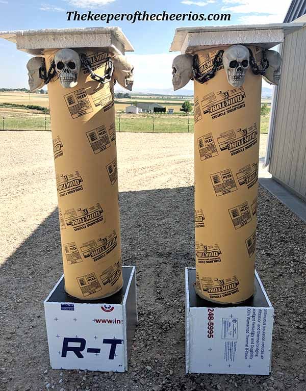 two fire hydrants made out of cardboard boxes with skulls on the top and bottom