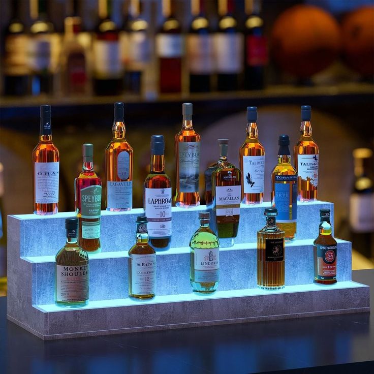 several bottles of alcohol are lined up on a shelf