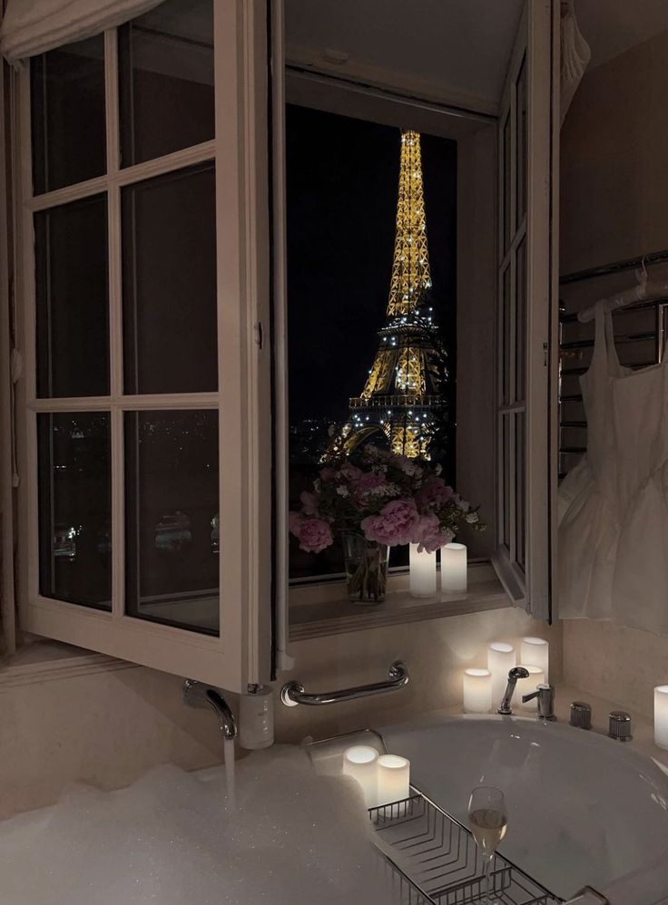 a bathroom with candles lit in front of the eiffel tower