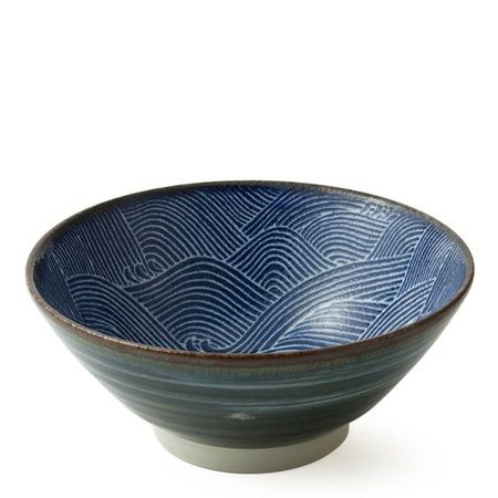 a blue and white bowl sitting on top of a table