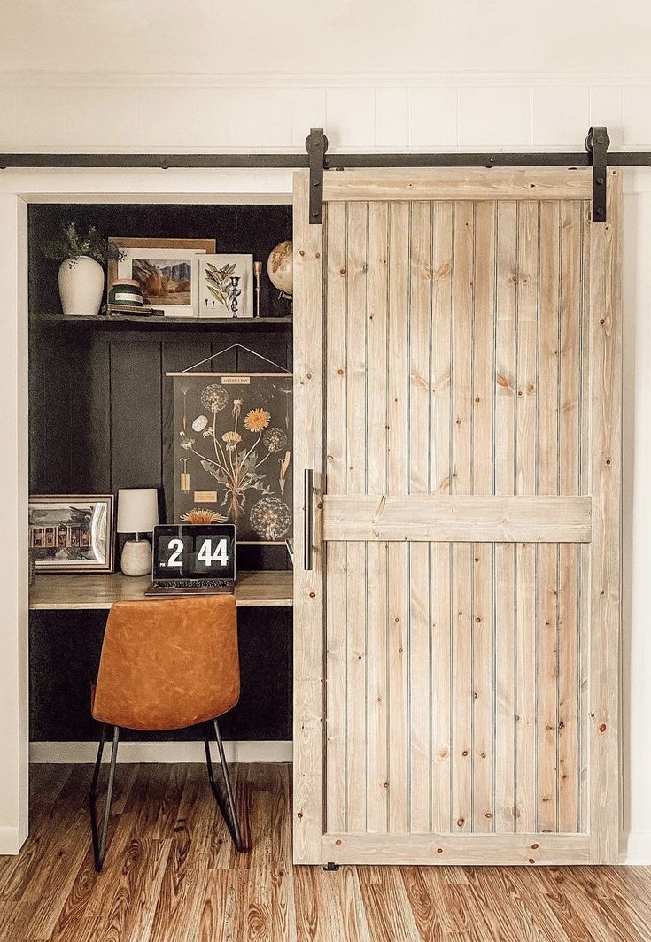 an office area with a desk, chair and sliding door