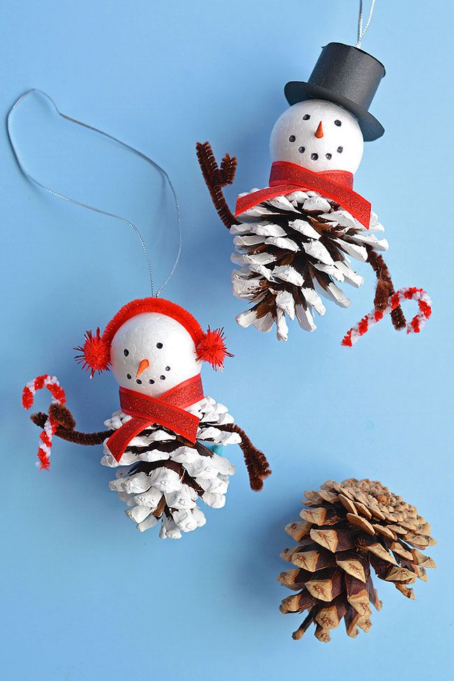 two pine cones and one snowman made from pine cones