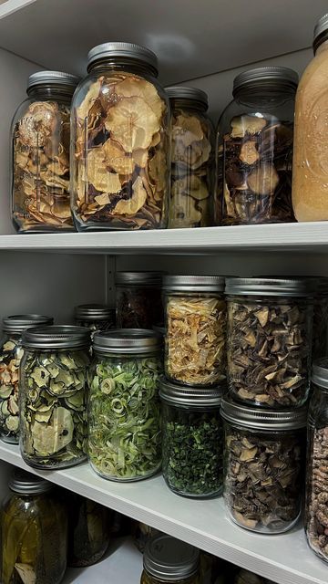 many jars filled with different types of food on shelves in a pantry or storage room