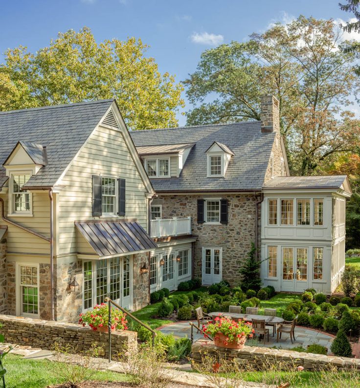 a large house with lots of windows and landscaping