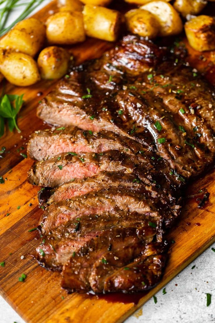 steak and potatoes on a wooden cutting board