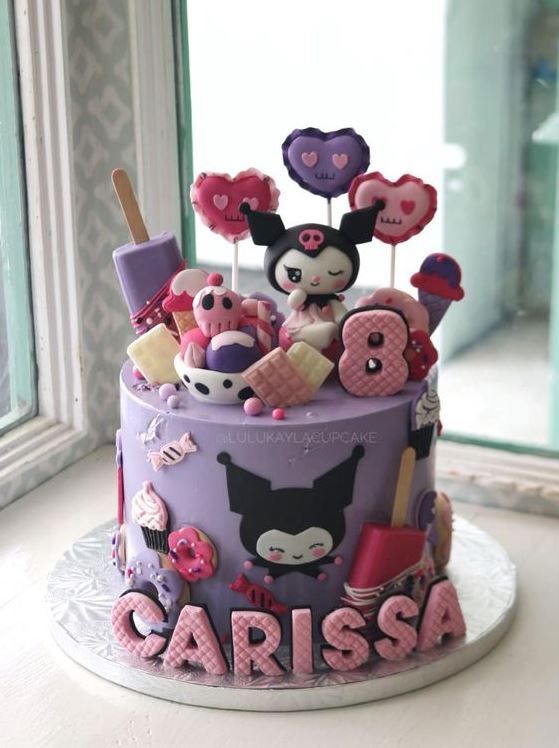 a purple cake with mickey mouse toppers on it's side and the word carissa spelled out in pink