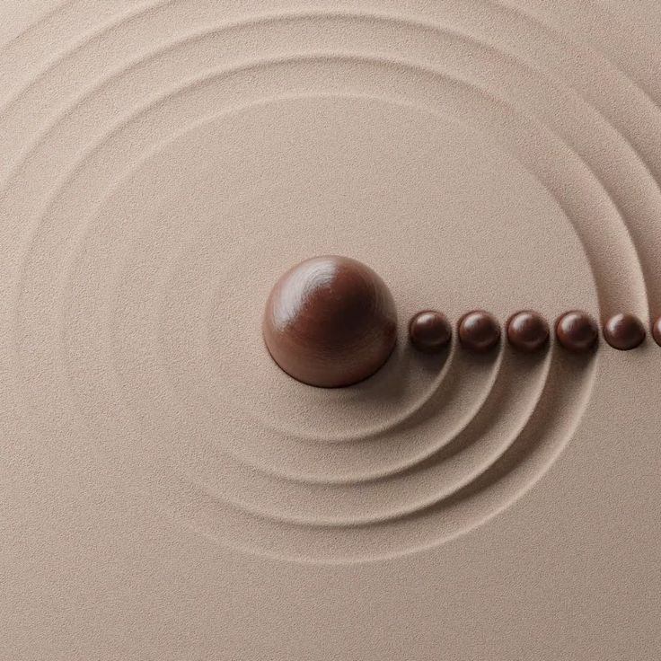 a brown object is in the middle of a circular pattern with two balls on it