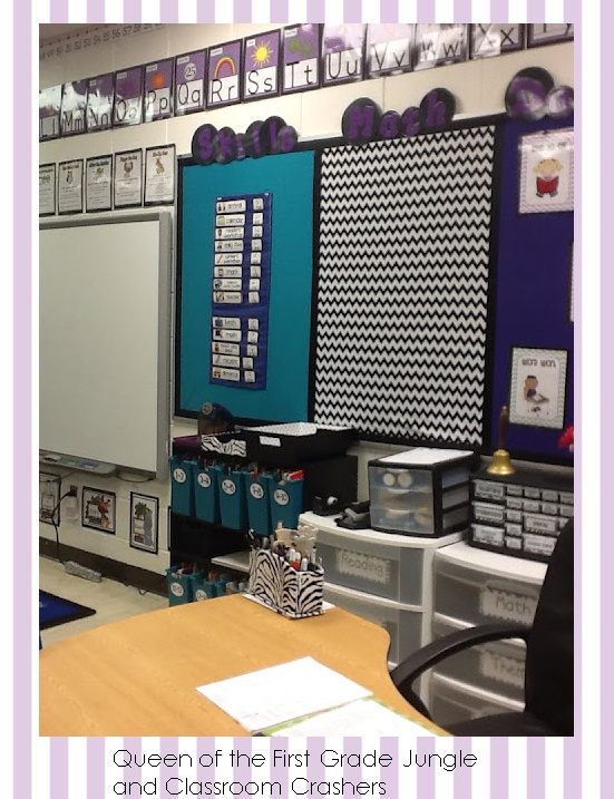 a classroom with purple and white wallpaper, zebra print on the back walls and black and white checkered bulletin boards