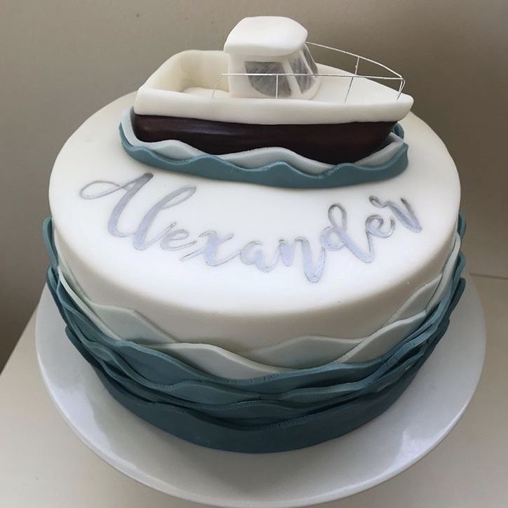 there is a cake with a boat on it and the words meranfoen written in frosting