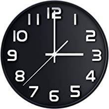 a large black clock with white numbers on the face is shown in front of a white background