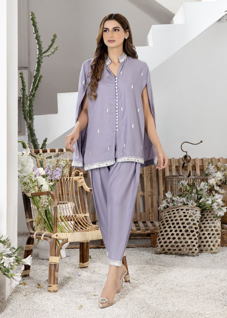 Lavendar cotton silk handworked cape with resham and mirrorwork details on front and back. Paired with matching skinny shalwar with same work on the bottom Luxury Lavender Dupatta For Festivals, Cotton Palazzo Set With Mirror Work In Traditional Drape, Eid Sets With Dupatta And Cape Sleeves, Designer Straight Kurta Pant Set With Mirror Work, Diwali Chanderi Pant Set With Mirror Work, Designer Mirror Work Straight Kurta Pant Set, Traditional Unstitched Sets With Cape Sleeves, Designer Cotton Lawn Suit With Mirror Work, Eid Chanderi Pant Set With Mirror Work