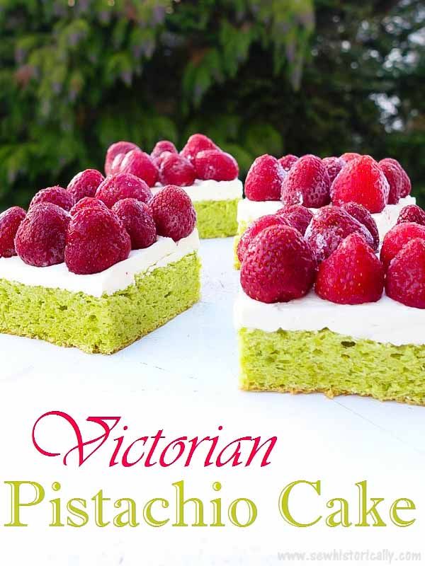 there is a green cake with raspberries on top and the words victoria pistachio cake above it