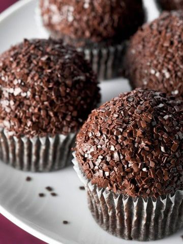 chocolate cupcakes with sprinkles on a white plate