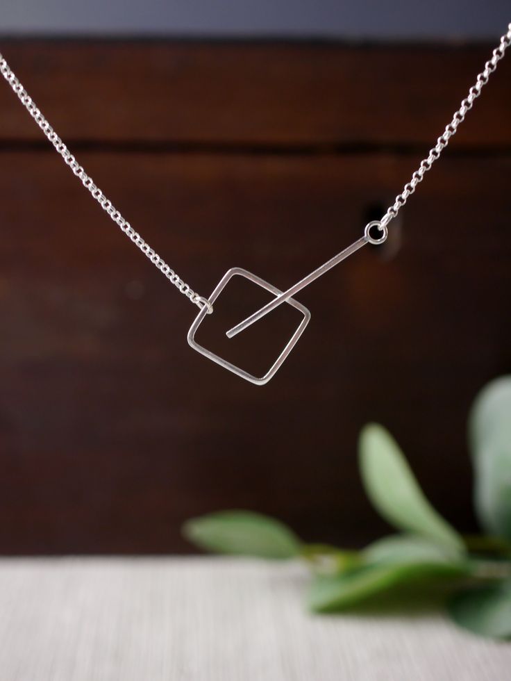 A minimal and contemporary silver pendant. Simple and stylish. A lovely geometric silver necklace. Handmade in sterling silver. Handmade in my studio in the beautiful city of Canterbury, England. Click the link to find out more..... #minimalsilverpendant #lovesquares #loveminimalism #simpleandstylish #handmadesilverpenant #everydaypendant #strikingpendant #edgypendant #funkypendant #statementnecklace #simplestatementnecklace Handmade Silver Jewelry Minimalist, Handmade Sterling Silver Jewelry, Gold Jewelry Simple Earrings, Statement Silver Necklace, Minimalist Silver Necklace, Geometric Silver Jewellery, Canterbury England, Jewellery Simple, Contemporary Handmade Jewelry